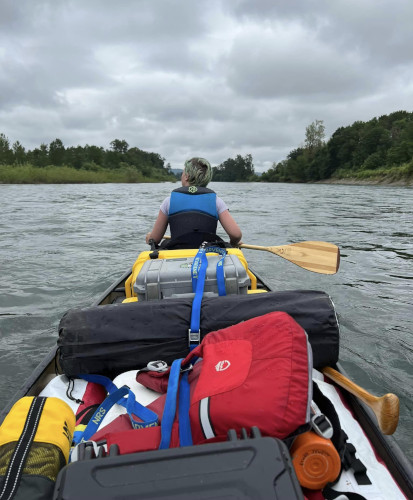 OSG Pathfinder paddling down a river at paddle camp.